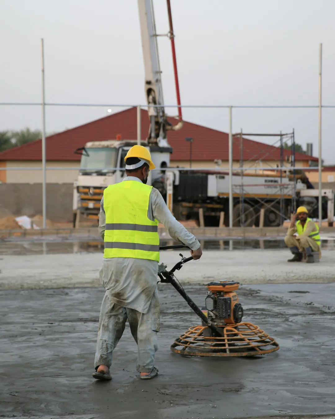 Worker finishing a concrete slab
